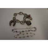 Two .925 fancy stone set bracelets; together with a chunky hollow Arabic charm bracelet. (3)