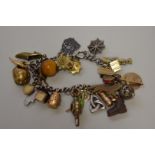 A silver charm bracelet, having assorted charms attached.