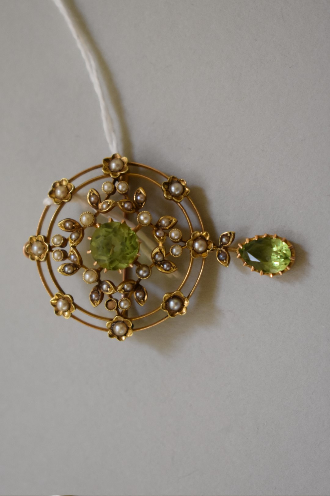 A peridot and seed pearl pendant brooch, stamped 15ct, 45mm, 6.6g total weight. - Image 2 of 3