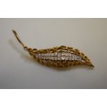 A contemporary diamond leaf gold brooch, hallmarked 375, 10.5cm long, 14.2g total weight.