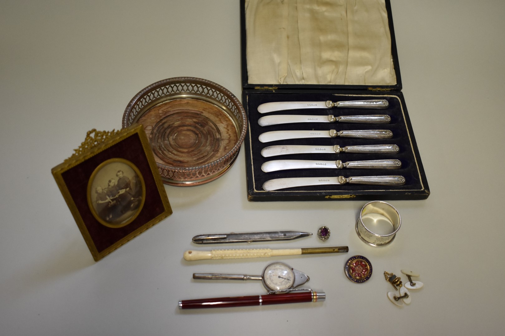 A Victorian silver napkin ring; together with a cased set of silver handled butter knives; and other