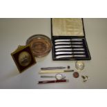A Victorian silver napkin ring; together with a cased set of silver handled butter knives; and other