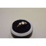 A diamond three stone gold ring, hallmarked 750, 1ct approximately, 4.1g total weight.