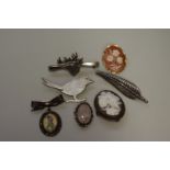 A selection of four silver brooches; together with three unmarked examples. (7)