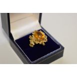An Andrew Grima style orange citrine yellow metal ring, probably 375, 9.3g total weight.