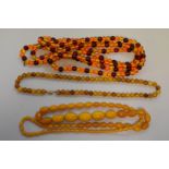 Three strings of amber coloured beads.