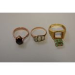 Three gem set unmarked yellow metal rings, set opal; emerald; and obsidian, 10.7g total weight. (3)