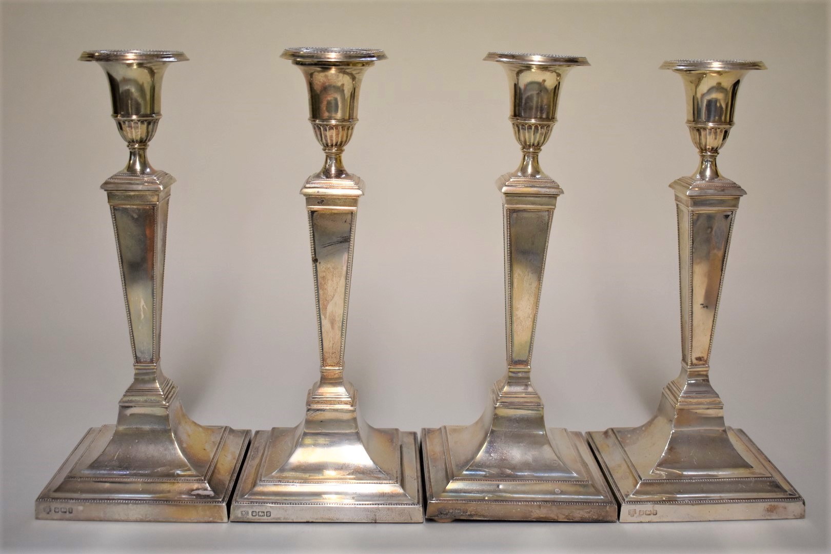 A set of four Edwardian silver candlesticks, by Hawsworth, Eyre & Co Ltd, Sheffield 1910/11, 25.