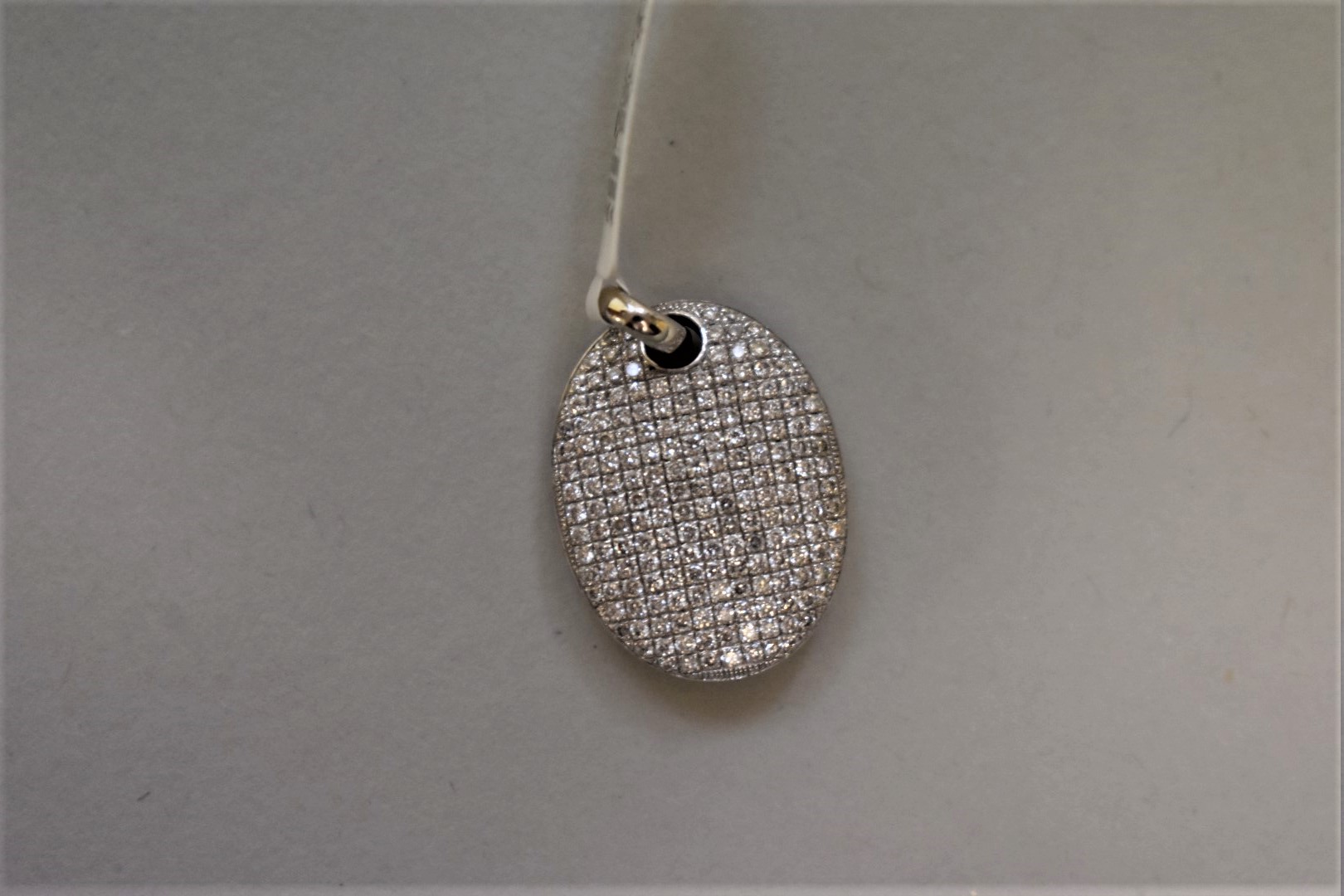A diamond encrusted white gold pendant, stamped 750, set diamonds, 0.8ct approximately.