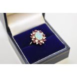 An opal, diamond and ruby white gold ring, stamped 18ct, 52g total weight.