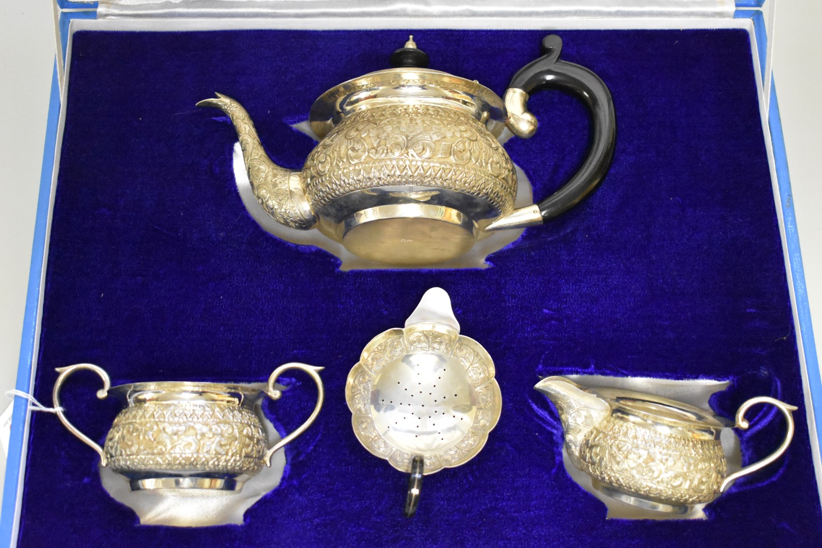 A cased Indian white metal four piece teaset, stamped 'silver' to base, 821g all in.