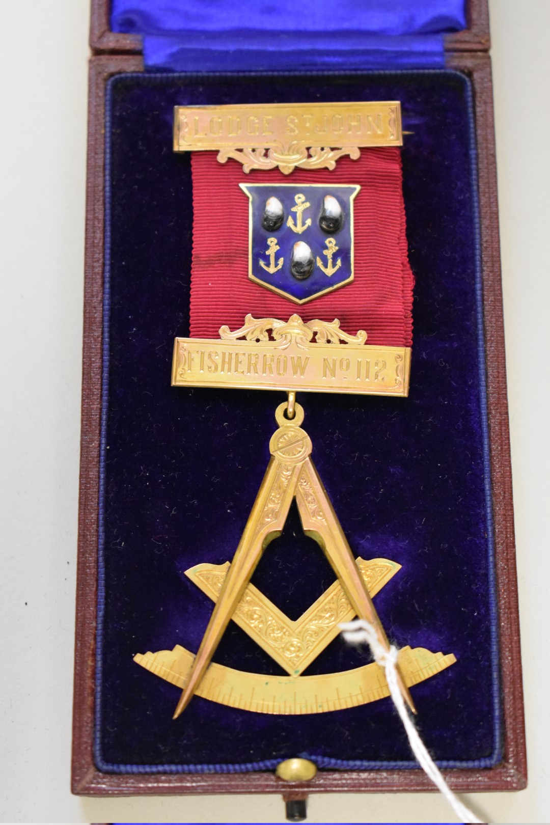 A cased gold and enamel Masonic medal, hallmarked 9ct in places, for the St. John Lodge, Fisher