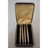 A cased set of four sterling silver engine turned bridge pencils.