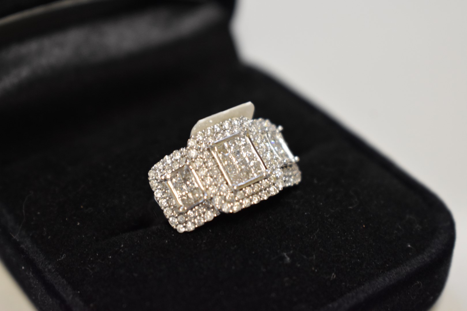 A diamond cluster white gold ring, stamped 750, set princess and brilliant cut diamonds, 1ct