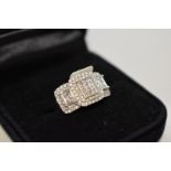 A diamond cluster white gold ring, stamped 750, set princess and brilliant cut diamonds, 1ct