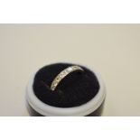 A diamond set unmarked white metal eternity ring, 4.2g total weight.