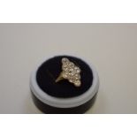 An Edwardian old cut diamond gold ring, the nine diamonds in a milgrain setting, 1.5ct