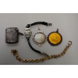 A silver vesta case, 17g; together with two medallions; and a ladies wristwatch, etc. (5)