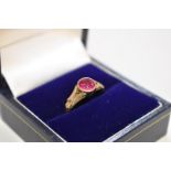 A collet set ruby unmarked yellow metal ring, 3g total weight.