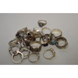 A quantity of silver and other metal rings, to include some stone set examples.