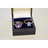 Two unmarked yellow metal dress rings, set amethyst and aquamarine, 7.2g total weight.