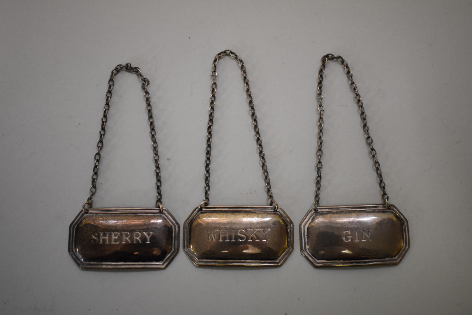 Three silver decanter labels, sherry, whisky & gin, by Francis Howard Ltd, Sheffield 1982/3/7, 28g.