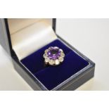 An amethyst and diamond unmarked yellow metal dress ring,  the diamonds approximately 1ct, 5.3g