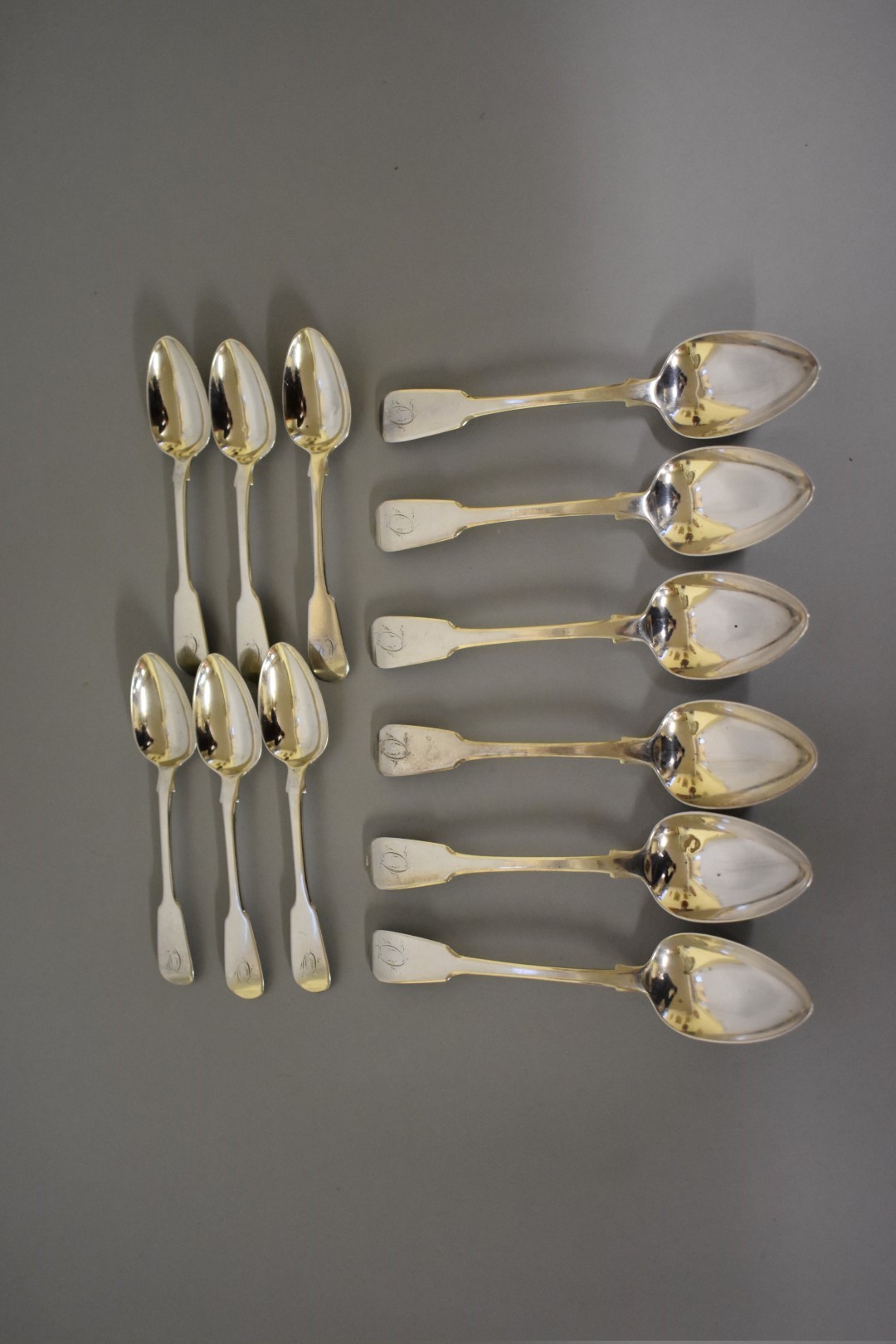 A set of six George III silver fiddle pattern dessert spoons, by Benjamin Davis, London 1825;