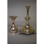 A Continental white metal candlestick, 23.5cm high; together with a similar baluster vase, 15cm