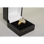 A baguette and brilliant cut diamond cluster gold ring, hallmarked 14ct, 1ct approximately, 6.1g