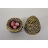 A silver surprise Easter egg, by Stuart Devlin, London 1972, containing pink onyx eggs in bird nest.