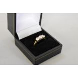 A brilliant cut diamond three stone gold ring, hallmarked 750, 0.75ct approximately, 4.2g total