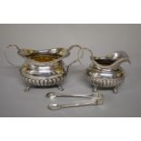 A Victorian silver sugar bowl and cream jug, maker's marks rubbed, London 1892; together with a pair