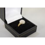 A diamond floral cluster gold ring, hallmarked 9ct, 2.7g total weight.