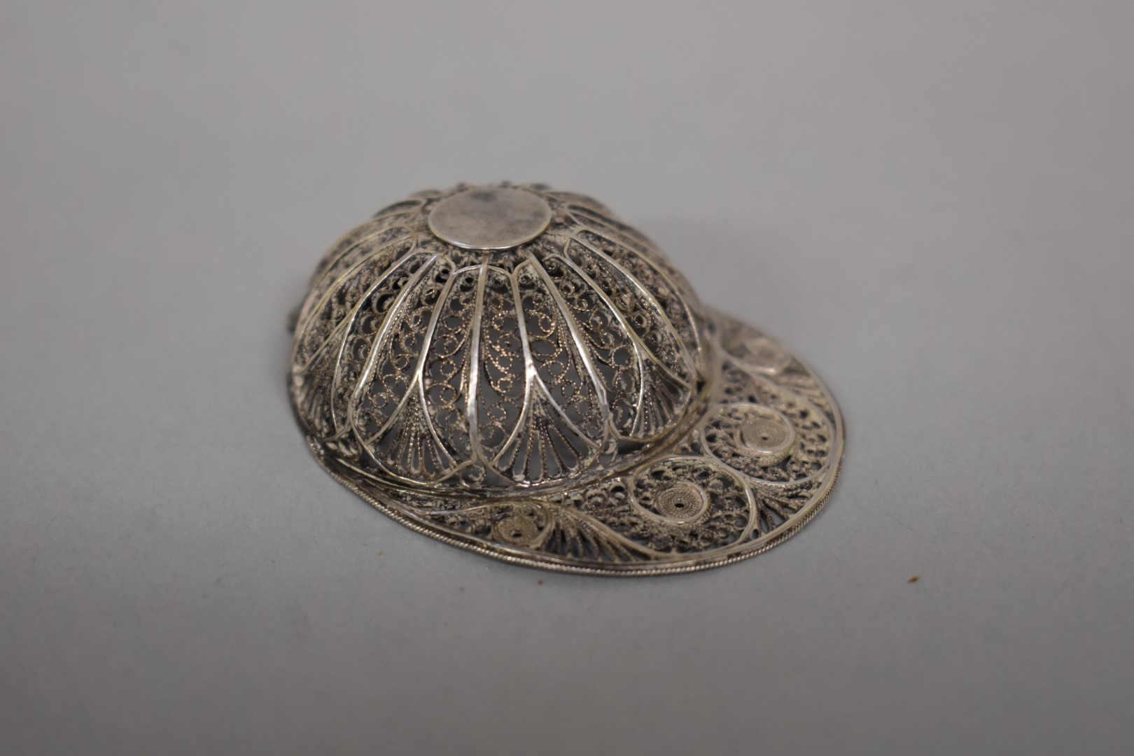 A Georgian silver filigree 'Jockey Cap' caddy spoon, possibly by Samuel Pemberton, 5.5cm long.