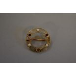 An amethyst and pearl circular gold brooch, stamped 15ct, 2.2cm, 2.9g total weight.