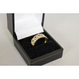 A diamond latticed gold ring, hallmarked 9ct, 3.8g total weight.