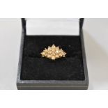 A fancy brown diamond cluster gold ring, hallmarked 9ct, 0.80ct approximately, 2.6g total weight.