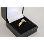 An opal gold ring, hallmarked 18ct, 4.5g total weight.