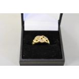 A diamond set gold knot ring, hallmarked 14ct, approximately 0.15ct, 3.9g total weight.