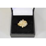 A diamond swirl set gold cluster ring, hallmarked 9ct, approximately 0.5ct, 3.4g total weight.