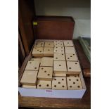 A good and unusual set of oversized birch, walnut and oak dominoes, each 13.5cm wide, in mahogany