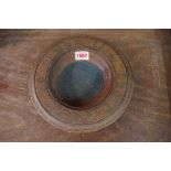 An old oak and brass inlaid circular alms dish, inscribed in Scottish Gaelic, 22cm diameter.