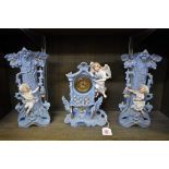 A Continental porcelain clock garniture, 28.5cm high.