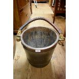 A cooped oak and brass bucket, with leather swing handle, 31cm diameter.