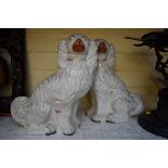 A pair of Victorian Staffordshire pottery dogs, 31cm high.