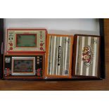 Four vintage Nintendo 'Game & Watch' hand-held computer games, comprising: Mickey Mouse; Fire