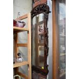 An antique carved walnut framed wall mirror, 78 x 31cm.