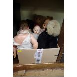 A collection of vintage dolls and teddies.