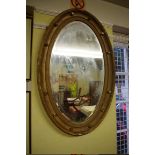 A Victorian gilt framed oval wall mirror, 99.5 x 64cm.